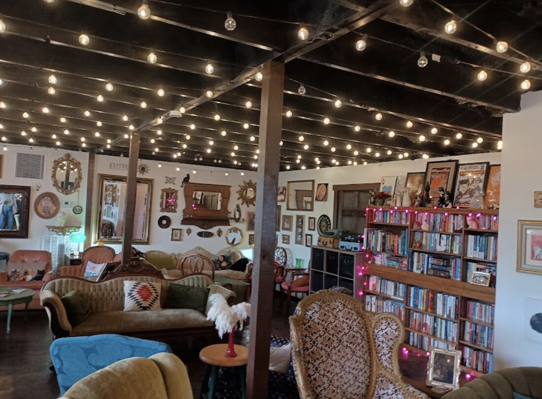 Lounge seating under string lights at Moody Cat Coffee Shop